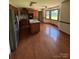 Kitchen boasts wood cabinets, island sink, stainless steel appliances, and natural light at 116 Lanes End Rd, Locust, NC 28097