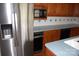 Kitchen features stainless steel refrigerator, black appliances, and tile backsplash at 116 Lanes End Rd, Locust, NC 28097