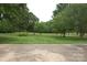 Well manicured front yard with trees and sprawling green space at 116 Lanes End Rd, Locust, NC 28097