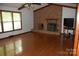 Living room featuring a brick fireplace, hardwood floors, and natural light at 116 Lanes End Rd, Locust, NC 28097