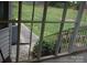 View from screened porch looking out at the grassy lawn, with an air conditioning unit nearby at 116 Lanes End Rd, Locust, NC 28097