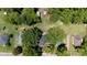 Aerial shot of home, surrounding trees, and neighborhood streets on a sunny day at 118 Sunset Dr, Clover, SC 29710