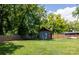 View of backyard featuring a metal-sided shed, grass, and privacy fence at 118 Sunset Dr, Clover, SC 29710