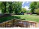 View from deck to backyard with grass, privacy fence, and storage shed at 118 Sunset Dr, Clover, SC 29710