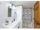 Bathroom with white vanity and cabinets, shower over bath with playful fish-themed curtain at 118 Sunset Dr, Clover, SC 29710