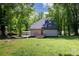 Rear view of home with gray roof, vinyl siding, red door, and grassy backyard at 118 Sunset Dr, Clover, SC 29710