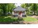 Charming home features a red front door, landscaped yard, and inviting front porch at 118 Sunset Dr, Clover, SC 29710