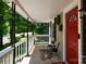 Covered front porch, showcasing comfortable seating and a bright red front door at 118 Sunset Dr, Clover, SC 29710
