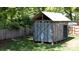 Backyard shed with metal roof and siding surrounded by grassy yard and trees at 118 Sunset Dr, Clover, SC 29710