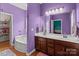 Bathroom featuring double vanity sinks, a soaking tub, and an integrated linen closet at 1230 Long Creek Ln, Salisbury, NC 28146