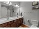 Bathroom featuring a double sink vanity with wood cabinets, and modern fixtures at 1230 Long Creek Ln, Salisbury, NC 28146