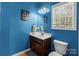 Bathroom featuring blue walls, a single vanity, and a mirror at 1230 Long Creek Ln, Salisbury, NC 28146