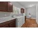 Laundry room with modern washer and dryer, sink, cabinets and marble countertops at 1230 Long Creek Ln, Salisbury, NC 28146