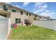 A well-maintained backyard with a patio, grill, play equipment, and a white privacy fence at 12408 Savannah Cottage Dr, Charlotte, NC 28273