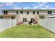The backyard has a privacy fence, green grass, and an outdoor dining set for entertaining at 12408 Savannah Cottage Dr, Charlotte, NC 28273