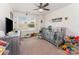 Cozy bedroom features a crib, rocking chair, ceiling fan, and bright natural light at 12408 Savannah Cottage Dr, Charlotte, NC 28273