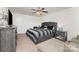 Main bedroom featuring a king bed, ceiling fan, and neutral decor throughout at 12408 Savannah Cottage Dr, Charlotte, NC 28273