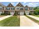 Charming townhomes featuring attached garages, manicured lawns, and stylish exterior finishes at 12408 Savannah Cottage Dr, Charlotte, NC 28273