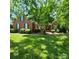 Charming brick home with a well-manicured lawn, mature trees, and classic architectural details at 1305 Yellowood Ct, Rock Hill, SC 29732