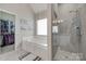 Bright bathroom featuring a garden tub, glass enclosed shower, and walk in closet at 1305 Yellowood Ct, Rock Hill, SC 29732