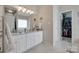 Bright bathroom featuring a double sink vanity with white cabinetry and a walk in closet at 1305 Yellowood Ct, Rock Hill, SC 29732