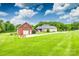 Beautiful property showcasing a well-maintained lawn, mature trees, and a charming brick garage at 1305 Yellowood Ct, Rock Hill, SC 29732