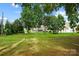 Sprawling lawn leading to a well-maintained home with a charming screened porch in a lush backyard at 132 Flora Vista Dr, Mooresville, NC 28117