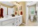 Bathroom featuring double sinks, a white vanity with storage, and an adjoining toilet and shower area at 132 Flora Vista Dr, Mooresville, NC 28117