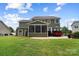 Rear exterior view showcasing a screened porch and outdoor entertaining area at 132 Flora Vista Dr, Mooresville, NC 28117