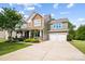 Charming two-story home with a well-manicured lawn, covered porch, and attached two-car garage at 132 Flora Vista Dr, Mooresville, NC 28117
