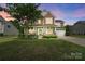 Charming two-story home with a well-manicured lawn, covered porch, and attached two-car garage at 132 Flora Vista Dr, Mooresville, NC 28117