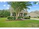 Charming two-story home with a well-manicured lawn, covered porch, and attached two-car garage at 132 Flora Vista Dr, Mooresville, NC 28117
