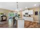Modern kitchen with granite countertops, white cabinets, and an island, offering ample workspace and stylish design at 132 Flora Vista Dr, Mooresville, NC 28117