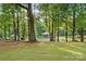 A serene waterfront property with a dock and boat lift nestled among mature trees at 132 Flora Vista Dr, Mooresville, NC 28117