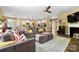 Bright open concept living space connects to the kitchen, featuring hardwood floors and a stylish brown sofa at 132 Flora Vista Dr, Mooresville, NC 28117