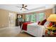 Cozy main bedroom featuring a ceiling fan, carpet floors, and several windows that let in ample natural light at 132 Flora Vista Dr, Mooresville, NC 28117