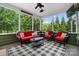 Cozy screened porch with comfortable seating and a view of the wooded backyard at 132 Flora Vista Dr, Mooresville, NC 28117