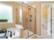 Tiled shower with glass enclosure, adjacent to soaking tub and a window that provides natural light at 132 Flora Vista Dr, Mooresville, NC 28117