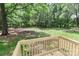 This back deck has wood railings and provides an ideal setting for relaxation and enjoying the surrounding nature at 1380 St. Johns Church Rd, Concord, NC 28025