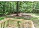 View of the backyard from the wooden deck overlooking the grass and trees at 1380 St. Johns Church Rd, Concord, NC 28025