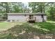 The backyard features a well-maintained lawn, trees, and a wooden deck, creating a relaxing outdoor space at 1380 St. Johns Church Rd, Concord, NC 28025