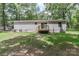 The backyard features a well-maintained lawn, trees, and a wooden deck, creating a relaxing outdoor space at 1380 St. Johns Church Rd, Concord, NC 28025