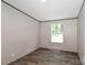 Bright bedroom with a window, and modern wood-look floors and neutral walls at 1380 St. Johns Church Rd, Concord, NC 28025