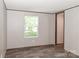 Bedroom with a bright window, modern wood-look floors, and neutral walls at 1380 St. Johns Church Rd, Concord, NC 28025