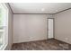 Empty bedroom featuring wood-look flooring and a door to the outside at 1380 St. Johns Church Rd, Concord, NC 28025