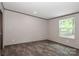 Bright bedroom with wood-look flooring and a large window at 1380 St. Johns Church Rd, Concord, NC 28025