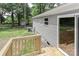 Close-up of the wooden deck with view of backyard, siding, AC unit, and sliding door at 1380 St. Johns Church Rd, Concord, NC 28025