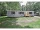 Charming single-story home with a gray exterior, black shutters, and a wooden porch at 1380 St. Johns Church Rd, Concord, NC 28025