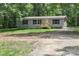 Charming single-story home with a well-maintained front yard and a gravel driveway at 1380 St. Johns Church Rd, Concord, NC 28025