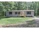 Inviting single-story home with gray siding, black shutters, and a newly-built wooden porch at 1380 St. Johns Church Rd, Concord, NC 28025